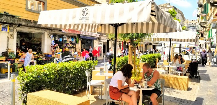 Diners at the Poppella Patisserie along a busy street in Naples, Italy.