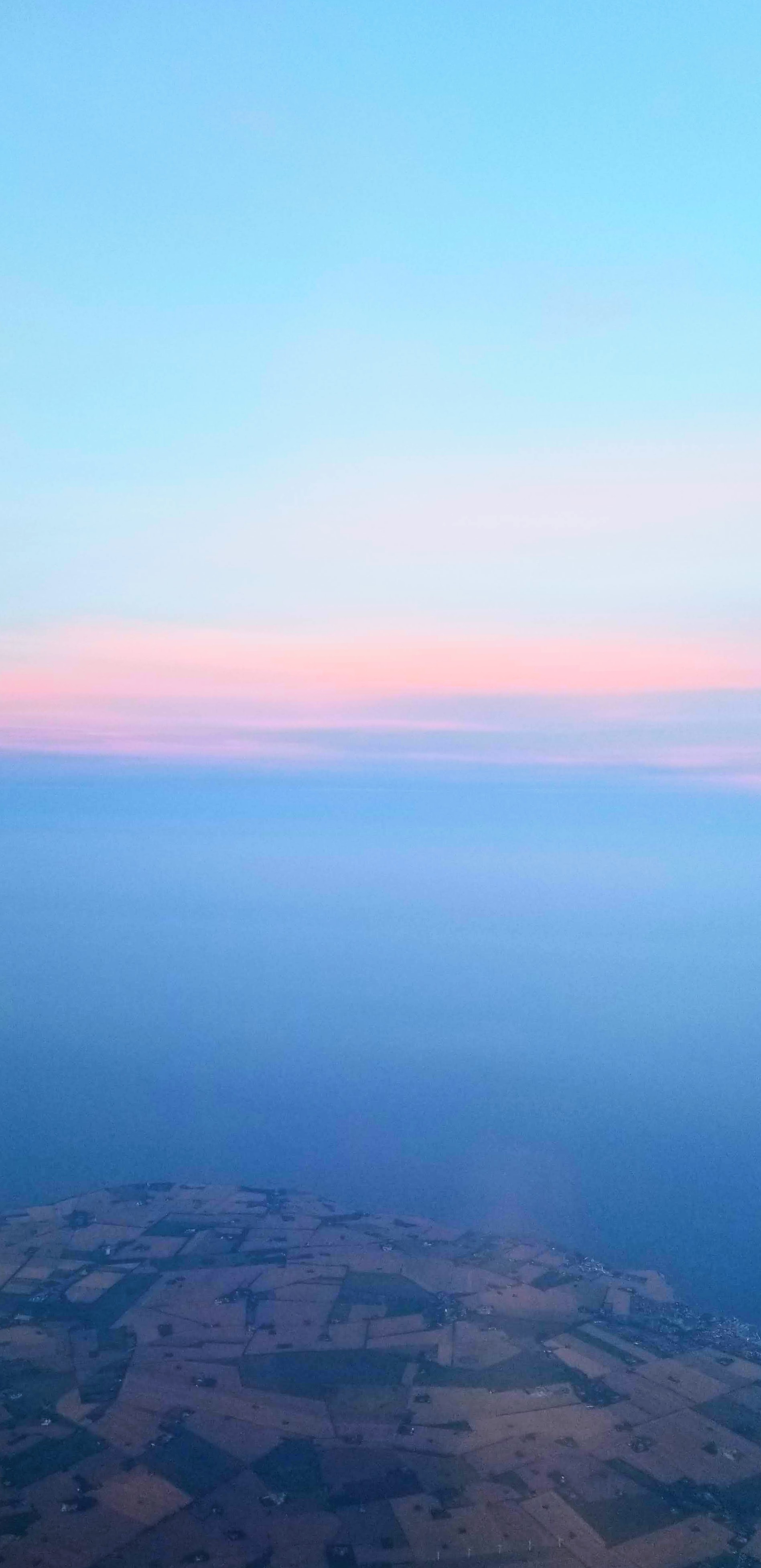 A pale sunset over the Denmark coast, photographed from the air.