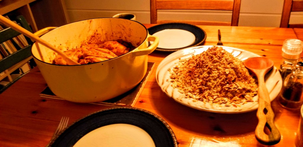 A photograph of a Moroccan stew and couscous on a dinner table.