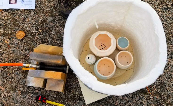 Photograph of pots inside a raku kiln.