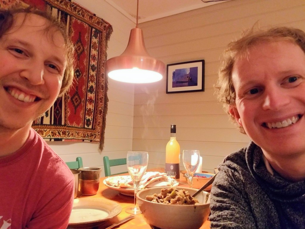 Selfie of two men in front of a dinner table.