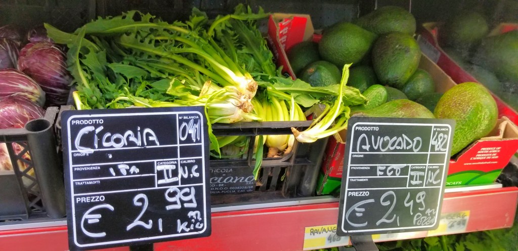 Photograph of chicory and avocados in a supermarket.